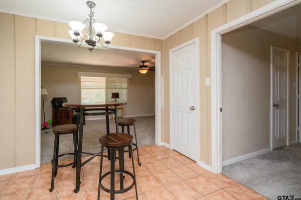a view of a dining room with furniture and chandelier