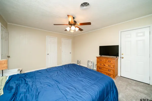 a bedroom with a bed and a flat screen tv