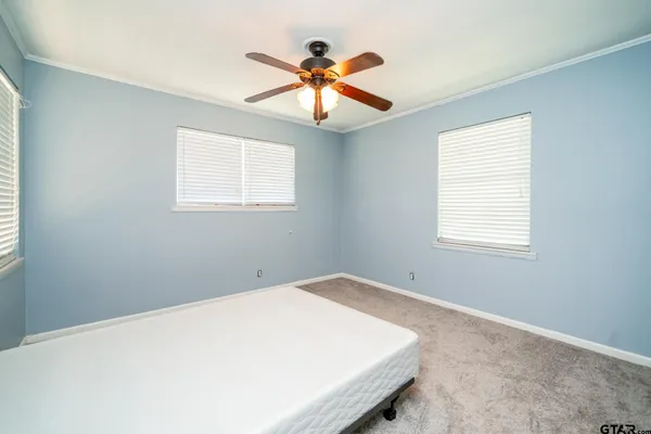 a view of a room with a ceiling fan and a window