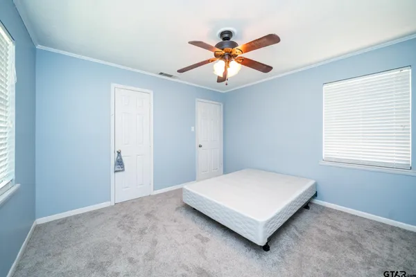 a bedroom with a bed and window