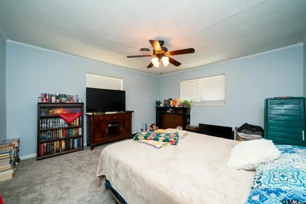 a bedroom with a bed and a flat screen tv