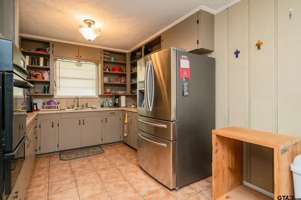 a kitchen with stainless steel appliances a refrigerator sink and cabinets