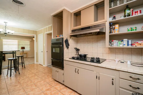 a kitchen with stainless steel appliances a cabinets and a counter space