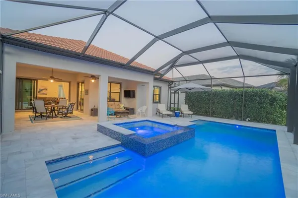a view of swimming pool with outdoor seating