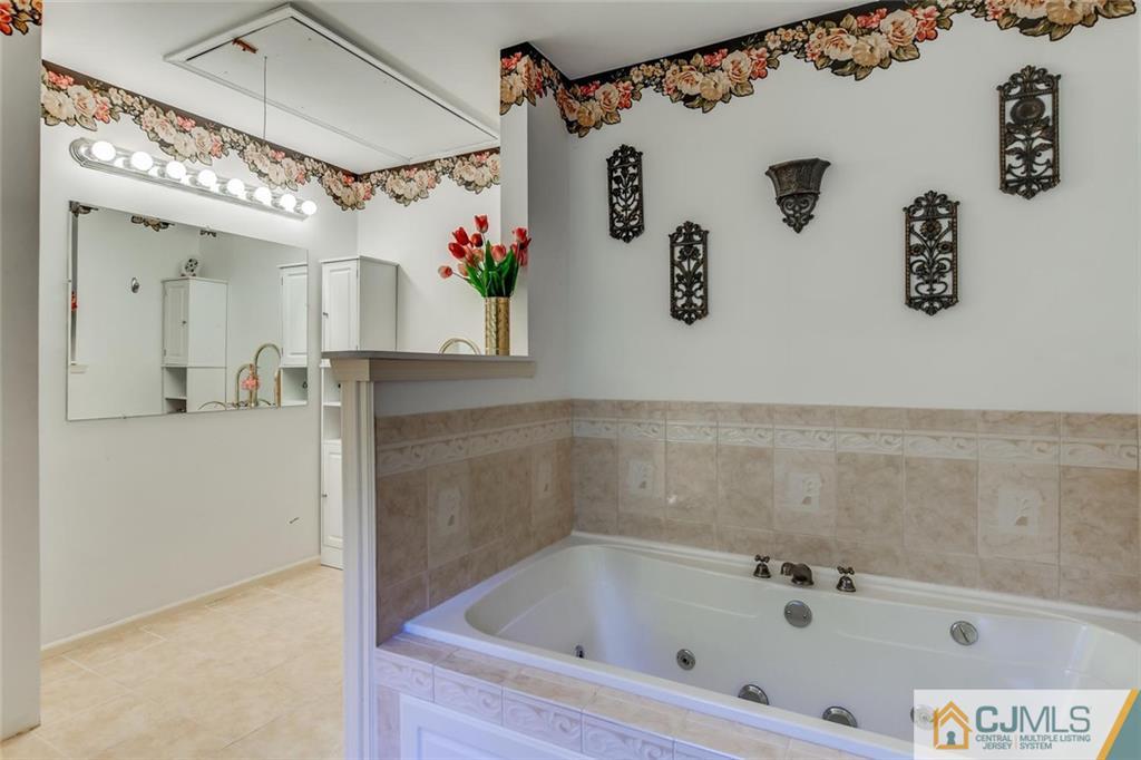 90 Union Valley Road Monroe Township, NJ 08831 - Photo 14 of 25 a bathroom with a bathtub and a shower