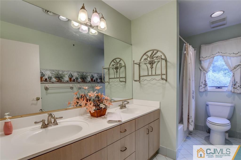 90 Union Valley Road Monroe Township, NJ 08831 - Photo 18 of 25 a bathroom with a toilet a sink and mirror