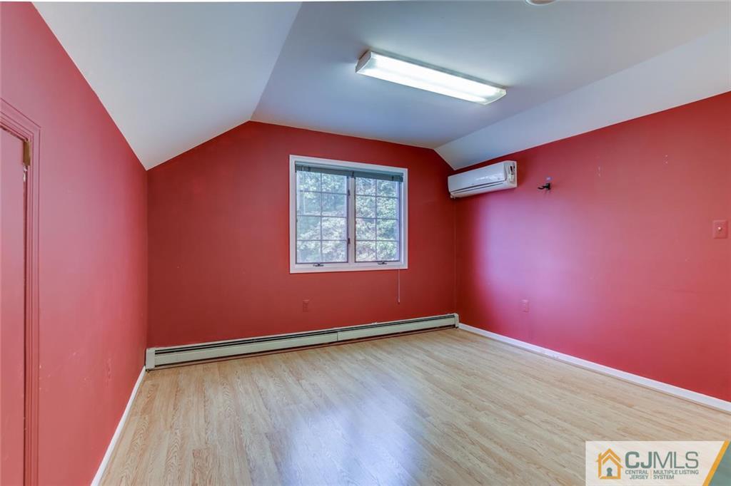90 Union Valley Road Monroe Township, NJ 08831 - Photo 20 of 25 an empty room with wooden floor and windows