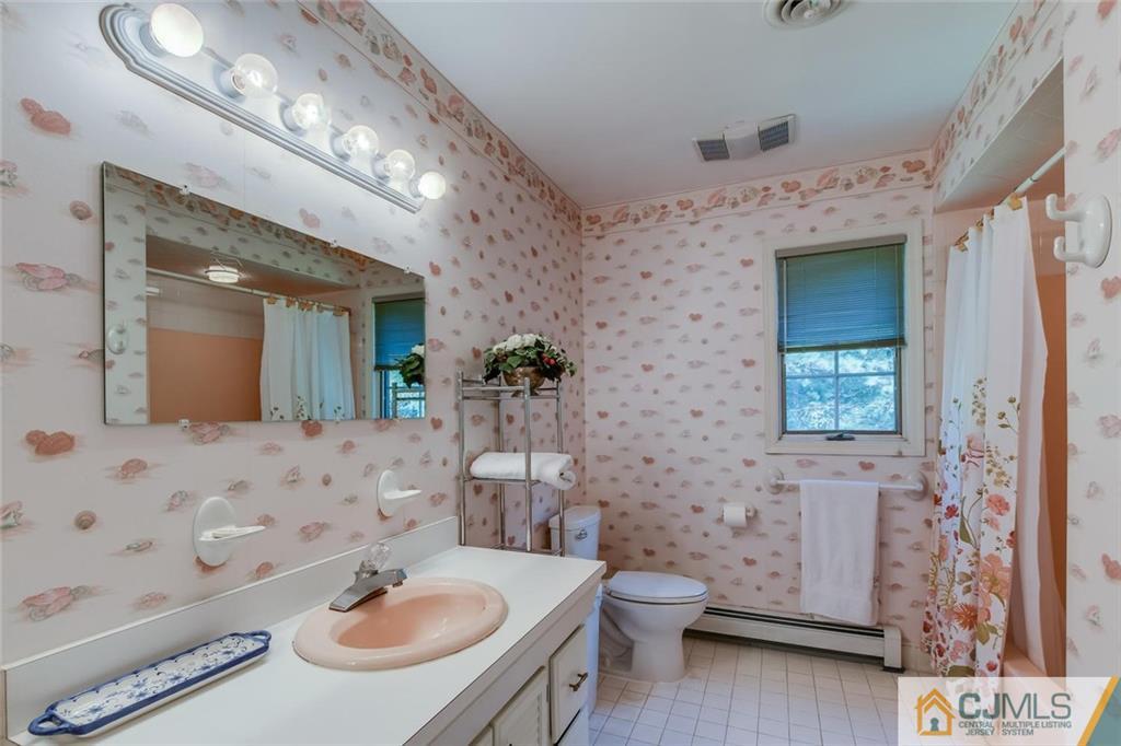 90 Union Valley Road Monroe Township, NJ 08831 - Photo 21 of 25 a bathroom with a sink a toilet and mirror
