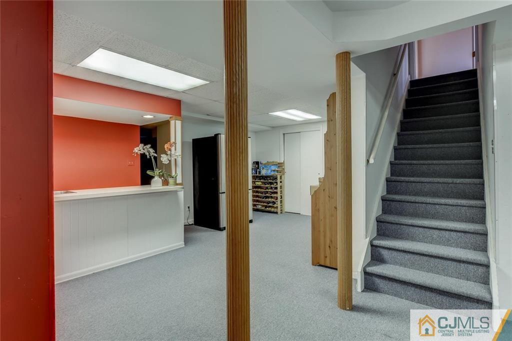 90 Union Valley Road Monroe Township, NJ 08831 - Photo 22 of 25 a view of a hallway with stairs and wooden floor