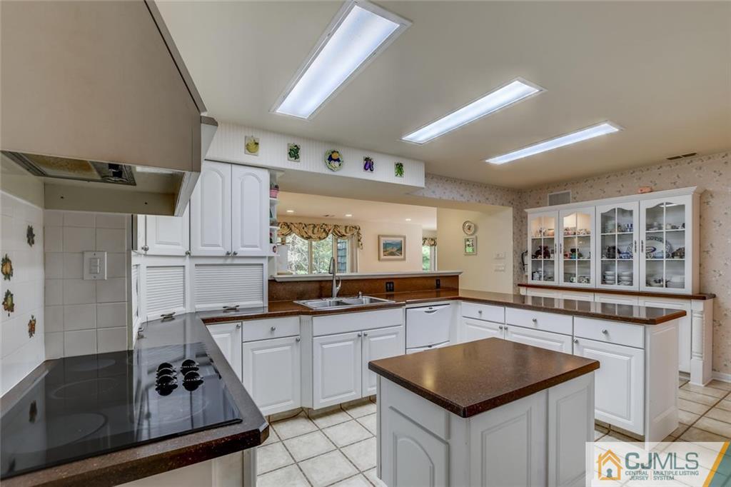90 Union Valley Road Monroe Township, NJ 08831 - Photo 5 of 25 a kitchen with granite countertop a sink stove and cabinets