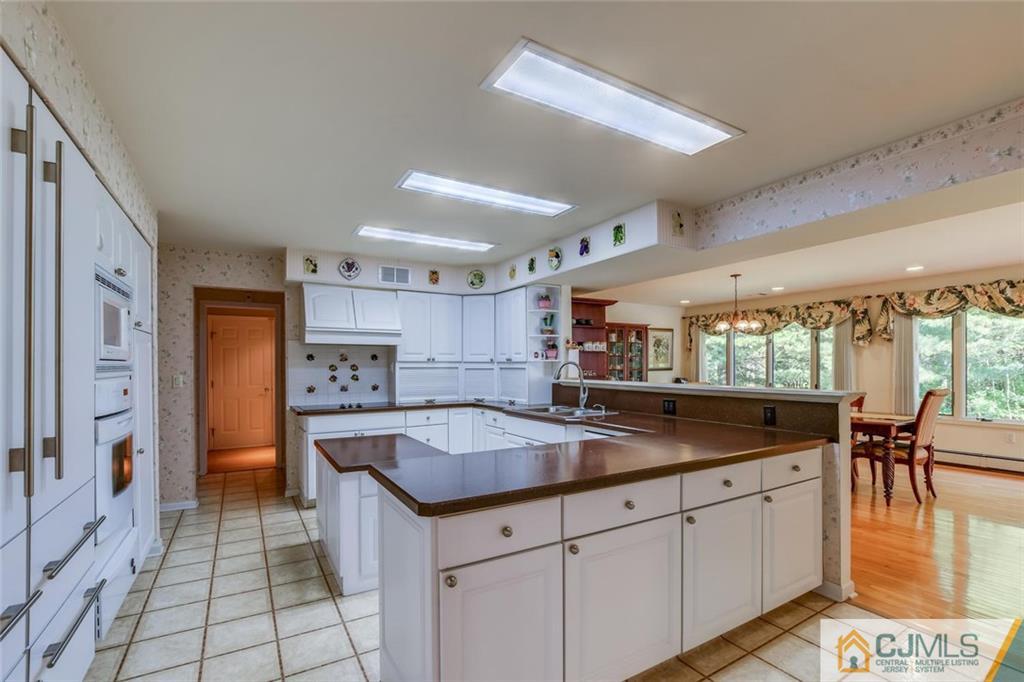 90 Union Valley Road Monroe Township, NJ 08831 - Photo 6 of 25 a kitchen with stainless steel appliances granite countertop a sink a stove and a refrigerator