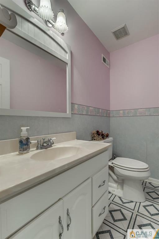 90 Union Valley Road Monroe Township, NJ 08831 - Photo 9 of 25 a bathroom with a sink a toilet and mirror