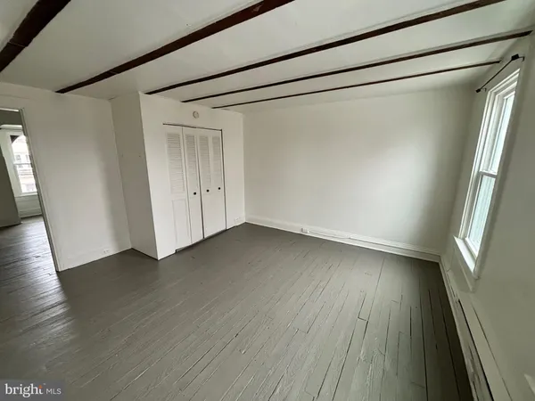 a view of a room with wooden floor and gate