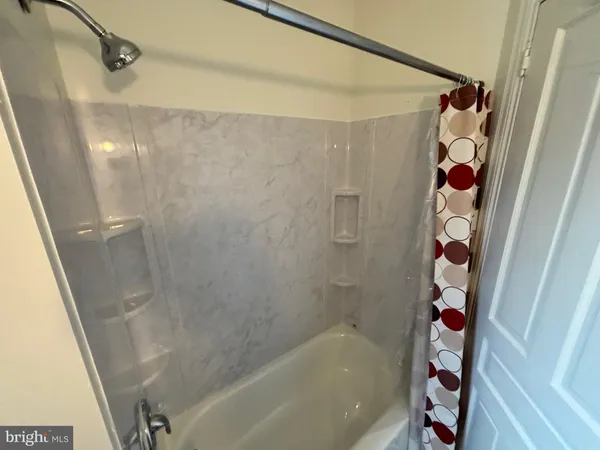 a bathroom with a bathtub and shower