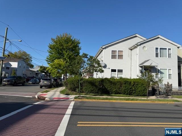312 Centre Avenue, Unit 1 Secaucus, NJ 07094 - Photo 1 of 17 a view of a white house with a small yard and large trees