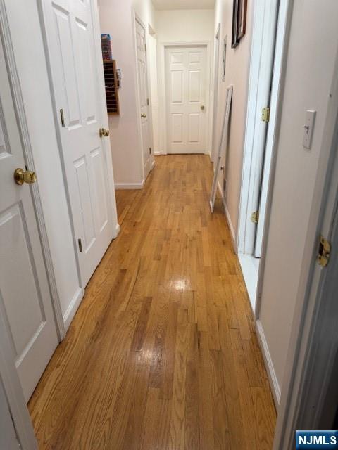 312 Centre Avenue, Unit 1 Secaucus, NJ 07094 - Photo 11 of 17 a view of a hallway with wooden floor and staircase