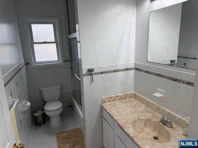 312 Centre Avenue, Unit 1 Secaucus, NJ 07094 - Photo 13 of 17 a bathroom with a granite countertop sink a toilet a mirror and shower