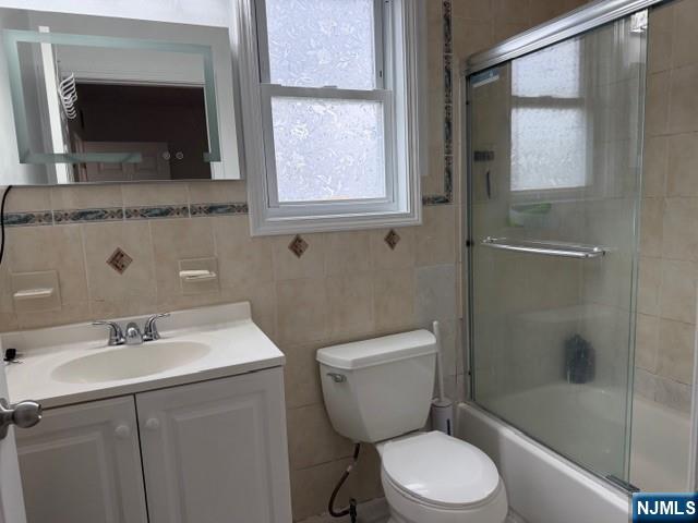 312 Centre Avenue, Unit 1 Secaucus, NJ 07094 - Photo 9 of 17 a bathroom with a granite countertop toilet sink and mirror