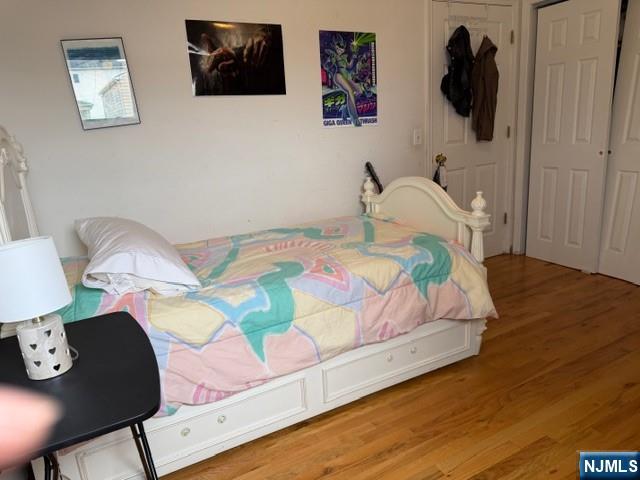 312 Centre Avenue, Unit 1 Secaucus, NJ 07094 - Photo 10 of 17 a bedroom with a bed and wooden floor