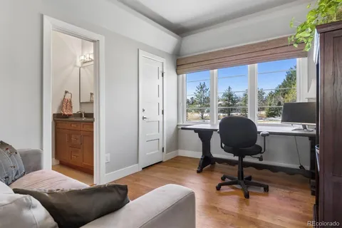 a living room with furniture and a book shelf