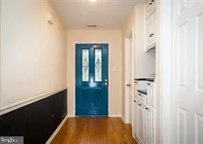 a view of a hallway with wooden floor