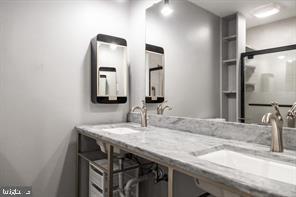 4 Victorian Court Chesterbrook, PA 19087 - Photo 22 of 39 a bathroom with a granite countertop sink and a mirror