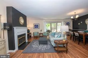 a living room with furniture a large window and a fireplace