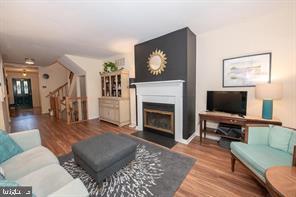 4 Victorian Court Chesterbrook, PA 19087 - Photo 29 of 39 a living room with furniture a flat screen tv and a fireplace