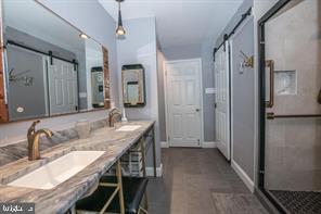 4 Victorian Court Chesterbrook, PA 19087 - Photo 31 of 39 a en suite bathroom with a granite countertop sink a mirror and shower