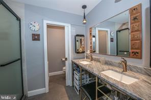 4 Victorian Court Chesterbrook, PA 19087 - Photo 32 of 39 a bathroom with a granite countertop sink a mirror and a shower