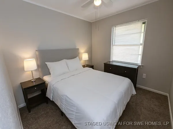 a large bed sitting in a bedroom next to a window