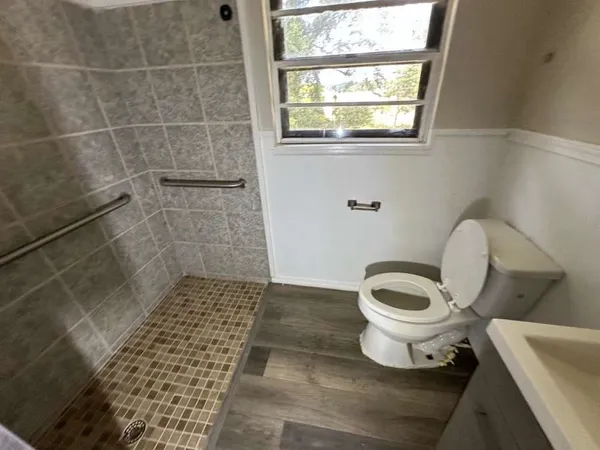 a bathroom with a toilet and a shower