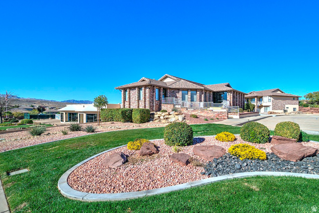 2212 Chippenham Court St. George, UT 84770 - Photo 36 of 75 View of front facade featuring brick siding and a front lawn