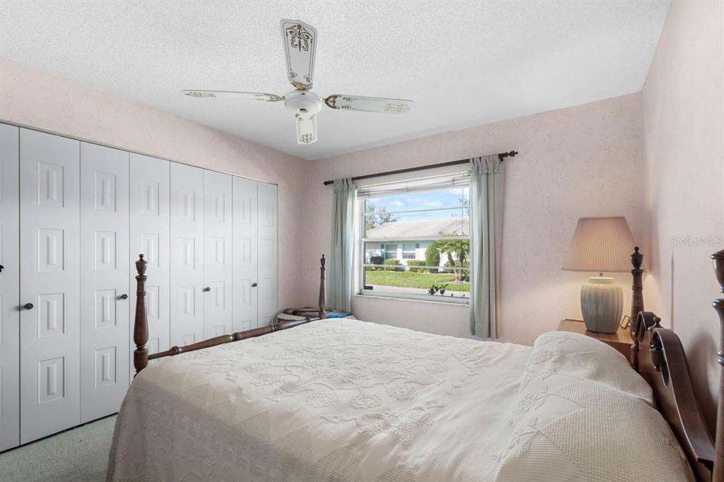 1602 Hovington Circle Sun City Center, FL 33573 - Photo 18 of 47 a bedroom with a bed and a chandelier