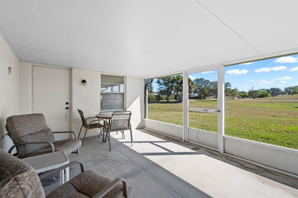1602 Hovington Circle Sun City Center, FL 33573 - Photo 21 of 47 a living room with furniture and a floor to ceiling window