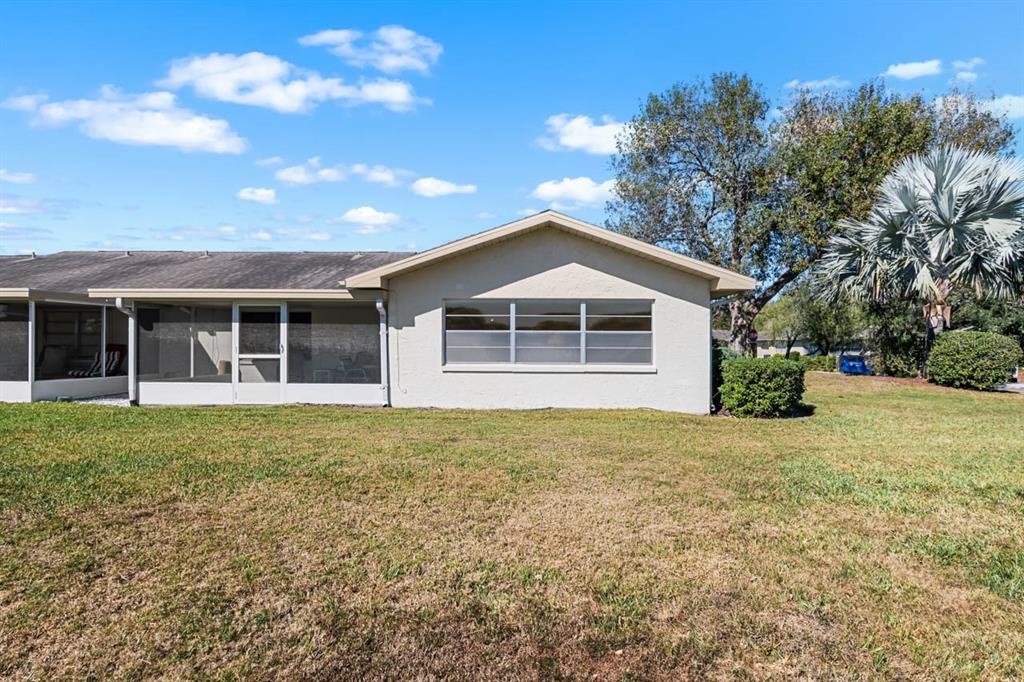 1602 Hovington Circle Sun City Center, FL 33573 - Photo 25 of 47 a front view of a house with a garden