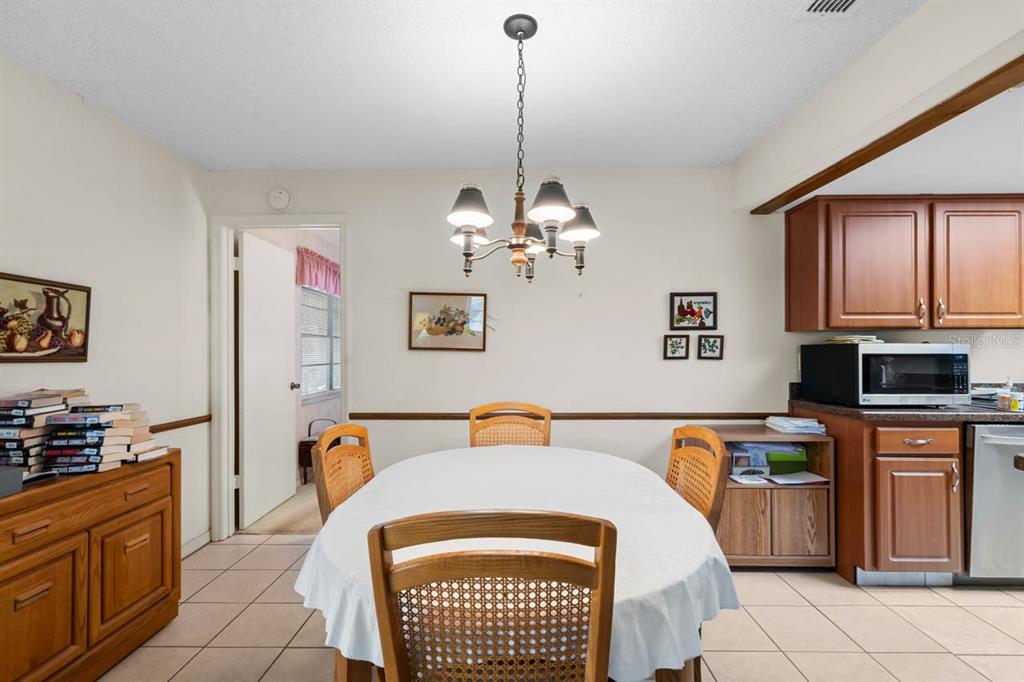 1602 Hovington Circle Sun City Center, FL 33573 - Photo 7 of 47 a bedroom with a bed and dresser