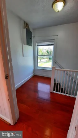 a view of wooden floor and windows in a room
