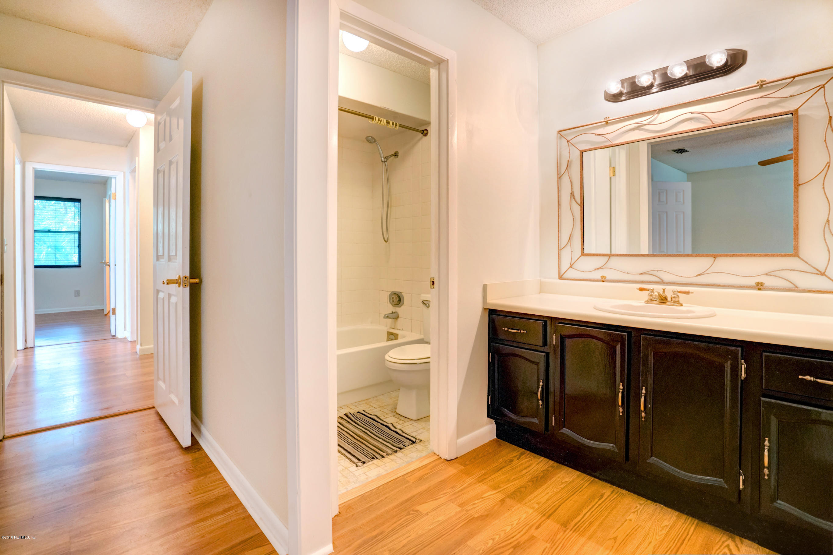2055 Derringer Road Jacksonville, FL 32225 - Photo 17 of 25 a bathroom with a sink vanity toilet and shower