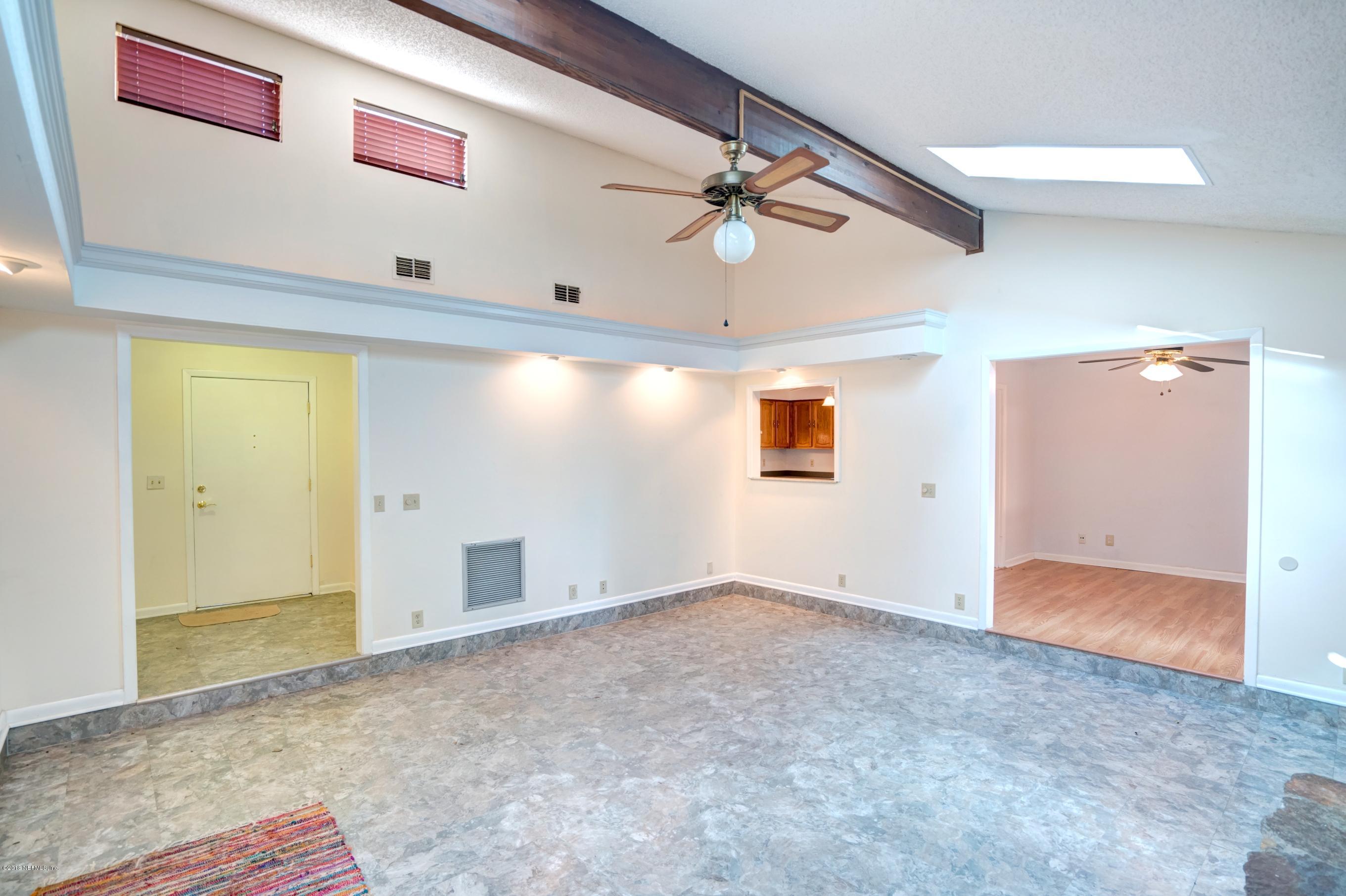 2055 Derringer Road Jacksonville, FL 32225 - Photo 5 of 25 an empty room with windows and fan