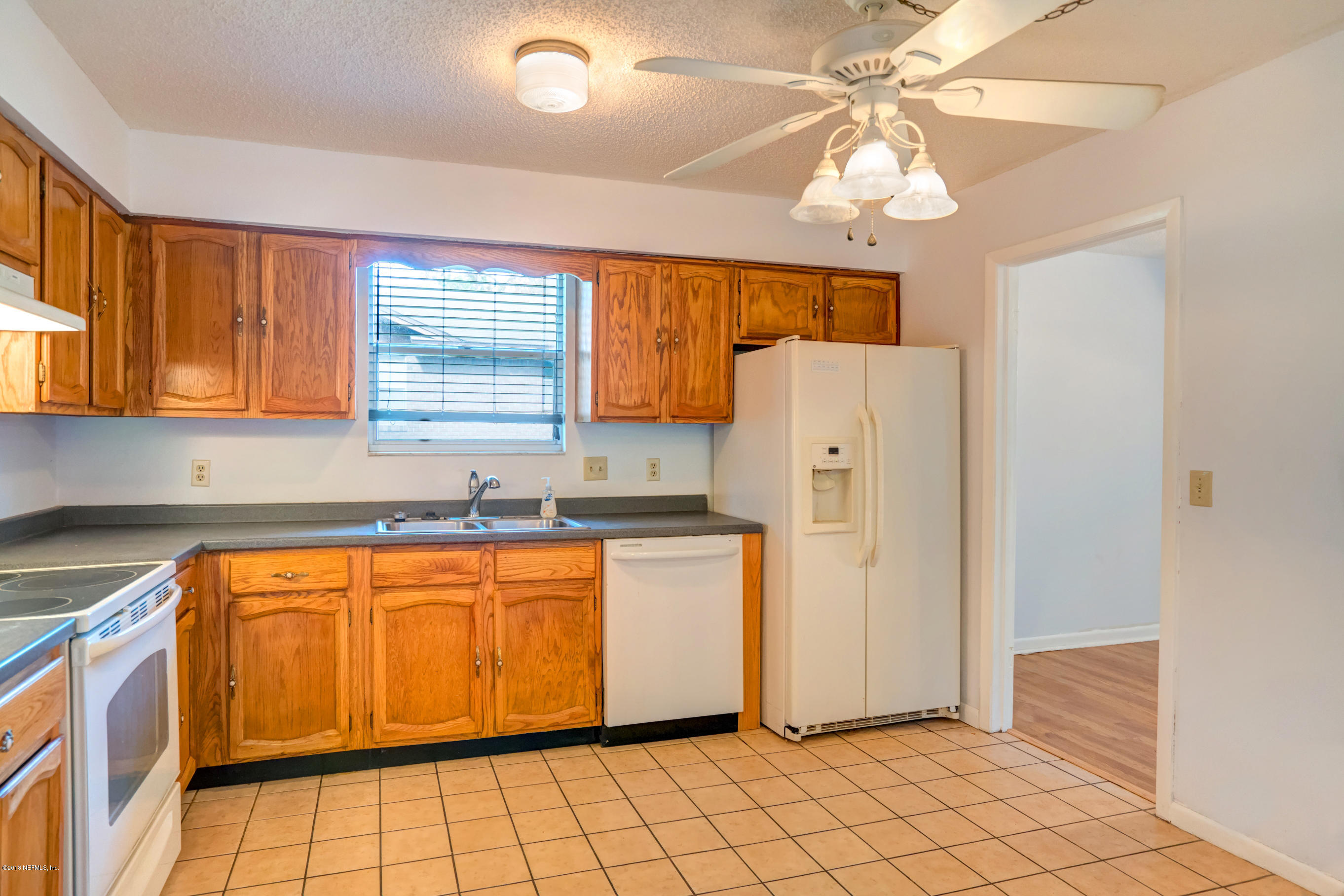 2055 Derringer Road Jacksonville, FL 32225 - Photo 7 of 25 a kitchen with stainless steel appliances a refrigerator sink and microwave
