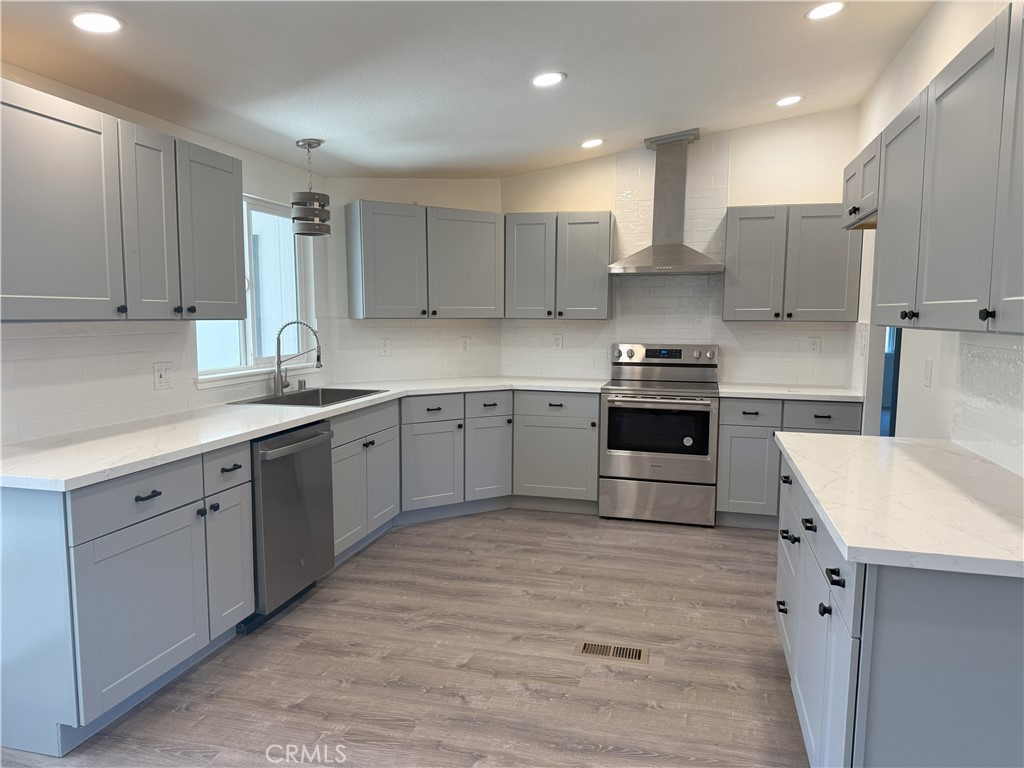 3835 Gardiner Ferry Road, Unit 98 Corning, CA 96021 - Photo 2 of 11 a kitchen with stainless steel appliances granite countertop a sink stove and refrigerator