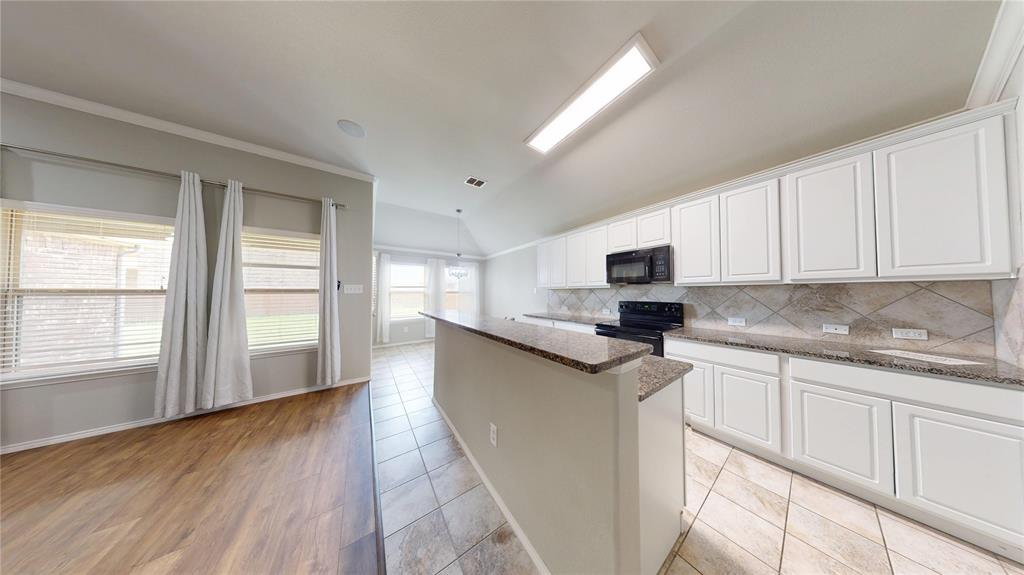 3101 Buckthorn Street Forney, TX 75126 - Photo 2 of 40 Kitchen featuring white cabinetry, granite countertops, tile backsplash, and integrated black appliances
