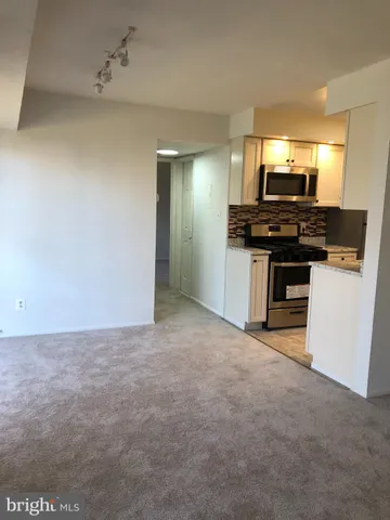 a kitchen with a stove and a refrigerator