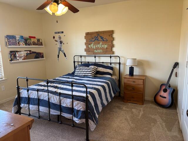 6303 112th Street Lubbock, TX 79424 - Photo 13 of 18 a bedroom with a bed and a chandelier