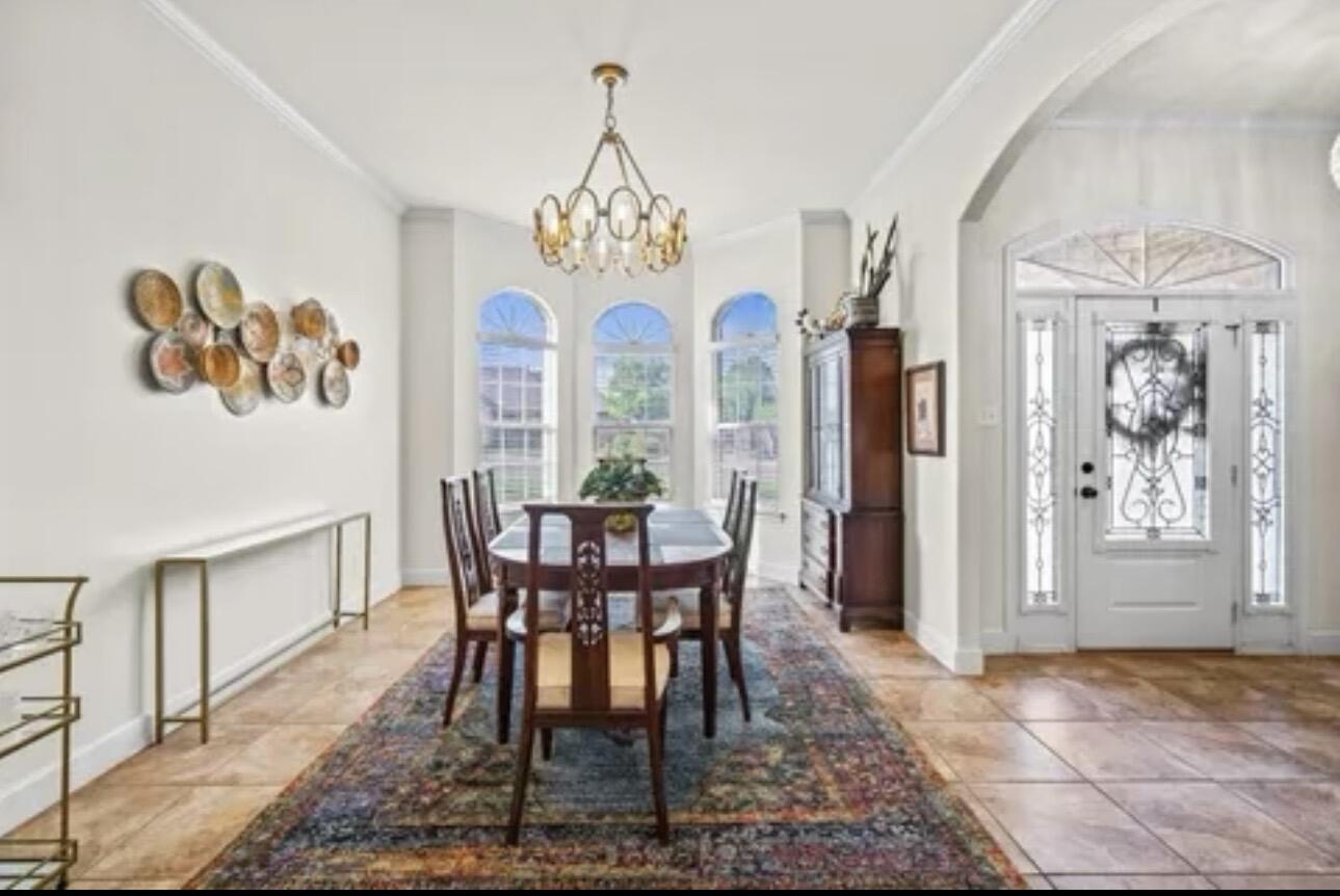 6303 112th Street Lubbock, TX 79424 - Photo 5 of 18 a view of a dining room with furniture a chandelier and wooden floor