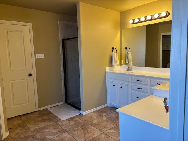 6303 112th Street Lubbock, TX 79424 - Photo 9 of 18 a spacious bathroom with a granite countertop sink and a mirror