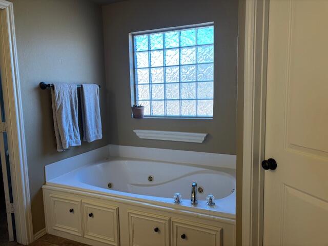 6303 112th Street Lubbock, TX 79424 - Photo 10 of 18 a bathroom with a bathtub and a window