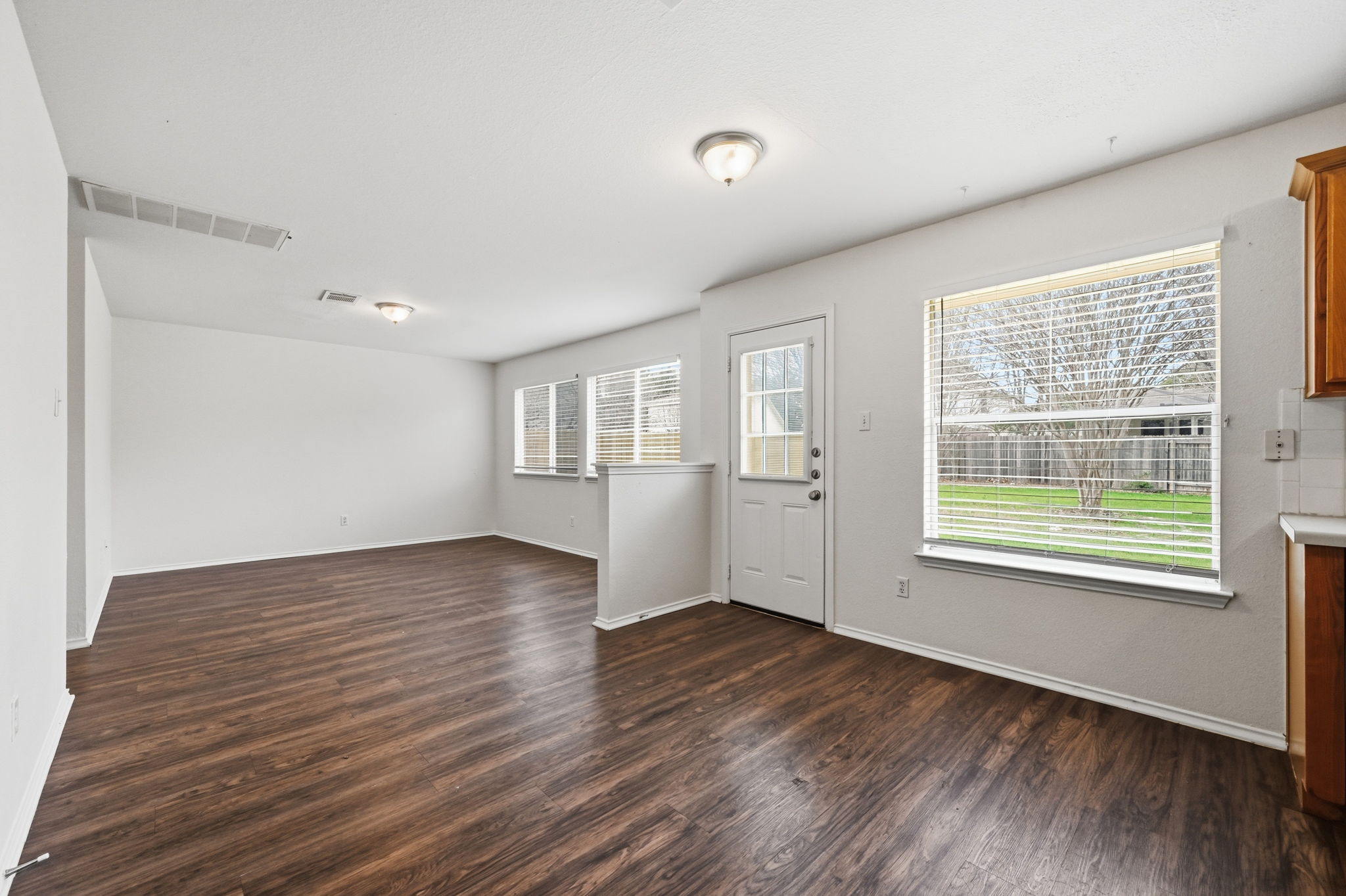 11145 Franklins Tale Loop Austin, TX 78748 - Photo 11 of 31 a view of an empty room with wooden floor and a window