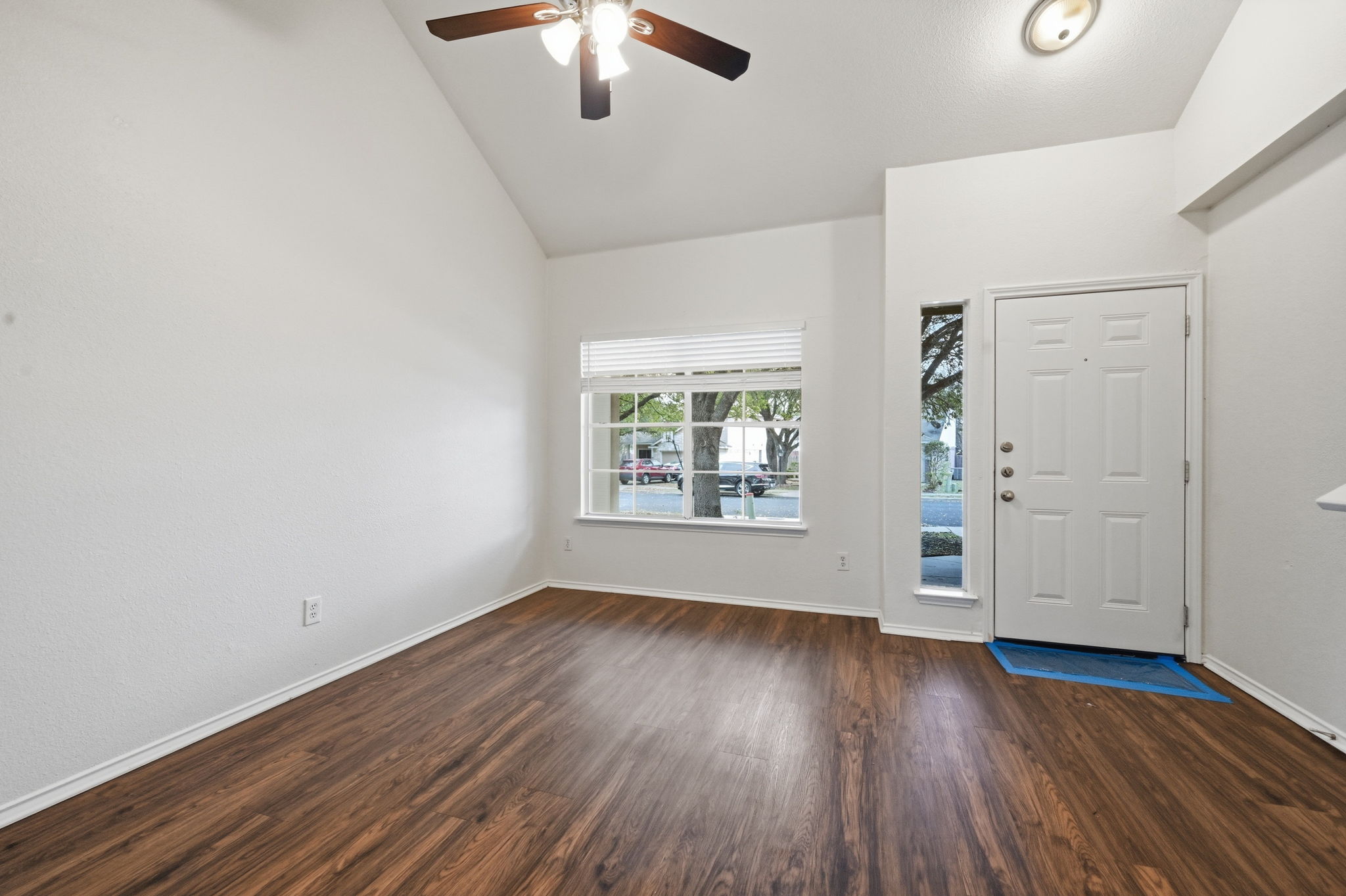 11145 Franklins Tale Loop Austin, TX 78748 - Photo 16 of 31 an empty room with wooden floor chandelier fan and windows